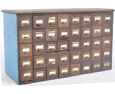 An early 20th Century multi drawer pigeon hole cabinet / industrial filling chest having five rows of eight drawers (40 drawe