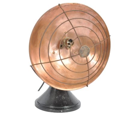 An early 20th Century Art Deco copper and cast iron heat lamp converted to a table lamp light having a UFO copper shade with 