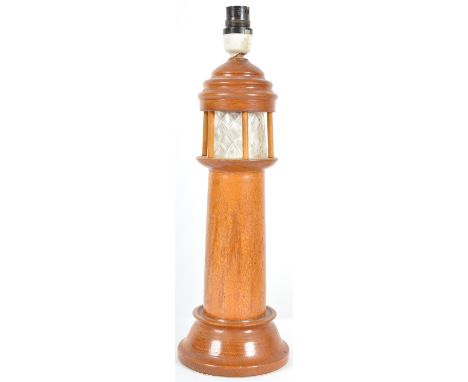 A retro mid 20th Century 1960s teak table lamp light in the form of a lighthouse having an etched frosted glass section below