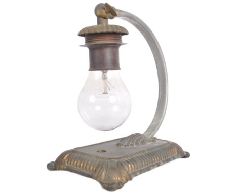 A vintage 20th Century cast iron arc table / desk lamp light having a hanging bulb via and arched arm raised on gadrooned bas