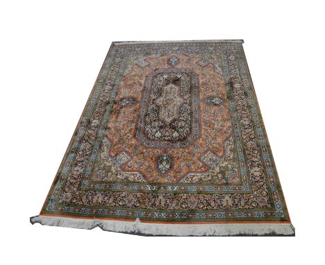 A Persian silk rug, central panel, floral decorated red ground with arrow head spandrels, border within guards, 161cm x 145cm