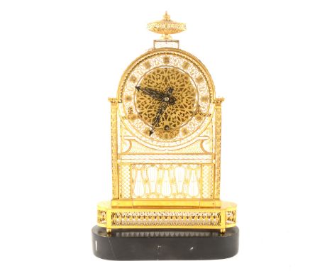 A French pierced brass and gilt metal mantel clock, the case profusely pierced and set with filigree work, the pierced dial w