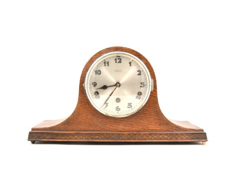 A 1940s oak mantel clock, with silvered dial, signed Kemp &amp; Co., Leicester, movement striking on four gongs, height 24cm.