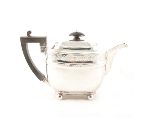 A Georgian silver teapot by John Emes, London 1806, engraved bands of foliate design with similar decoration to spout, raised