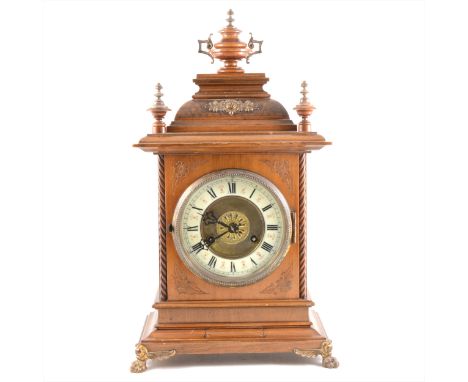 A German stained beechwood mantel clock, ivorine chapter ring, Junghans movement striking on a gong, 47cm.