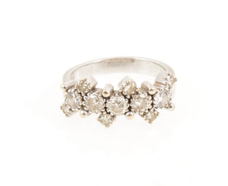 A diamond half hoop ring, five major diamonds individually claw set with three smaller diamonds set to top and bottom alterna