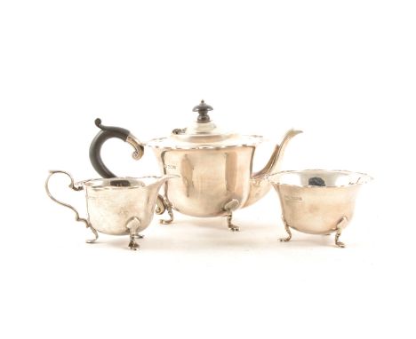 An Edwardian silver three-piece bachelor's teaset by RF Mosley &amp; Co., Sheffield 1907, scrolled outlines, each piece raise