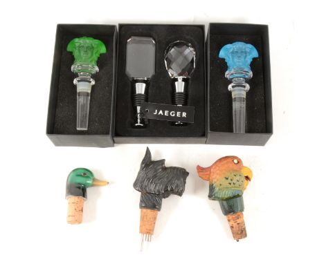 Two boxed Versace Medusa bottle stoppers - "Lumiere Green" and "Light Blue", a boxed set of two Jaeger glass stoppers, three 
