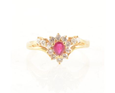A ruby and diamond cluster ring, the pear shape ruby claw set and surrounded by ten round brilliant diamonds, with a further 