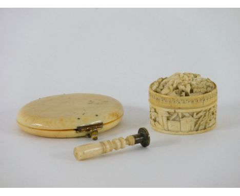 A Chinese ivory counter box, the domed top carved with figures with mother of pearl counters, 4cm diameter, a desk seal, and 