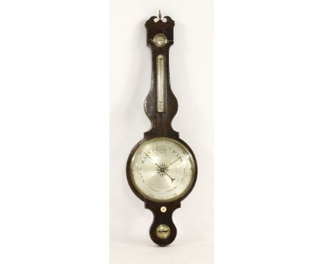 An oversized mahogany wheel barometer, the silvered dial, signed on the level Spencer & Co, London, set with thermometer and 