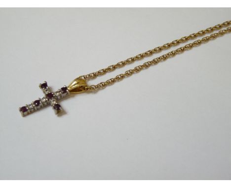 An 18ct gold ruby and diamond cross, suspended on a 9ct gold Prince of Wales chain