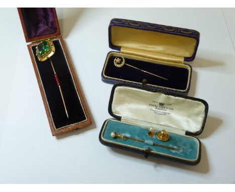 A late Victorian gold stick pin, set with a composite quartz stone, tested as approxiamtely 15ct gold, two pearl stick pins, 