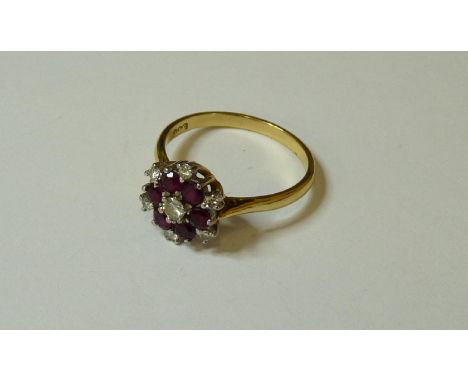 An 18ct gold ruby and diamond cluster ring