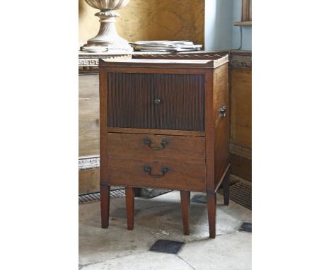 A Georgian mahogany commode, with a wavy edge gallery above two tambour fronted doors, over a draw-out lower section, with si