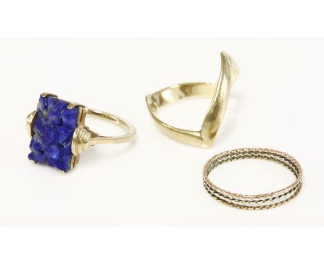 A 9ct gold wishbone ring, a three colour gold ring, and an Art Deco carved lapis lazuli plaque ring marked 9ct