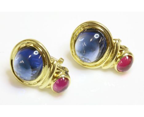 A pair of gold, cabochon sapphire and ruby earrings, circa 1980, an oval cabochon sapphire, rub set in a landscape position t
