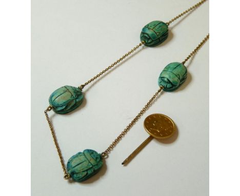 An early 20th century gold necklace, with faience scarabs marked 9c, a gold fetter chain, and a gold coin stick pin, broken