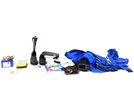 A group of motorcycle racing gear, comprising a Bellstaff blue stripe over jacket, a pair of Bellstaff leather motorcycle boo