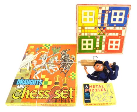 Toys and games, comprising a sailor puppet, six Chad Valley metal puzzles, a Bowick draughts and chess set and a Ludo board. 