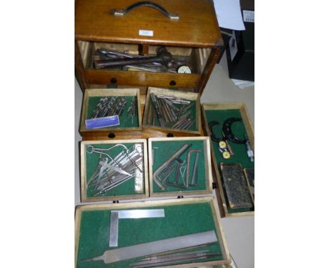 A vintage engineers toolbox with tools including taps; micrometres; callipers; a Chesterman tape measure; etc.