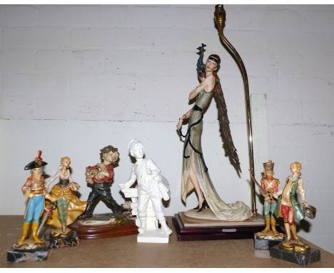 An Art Deco style resin table lamp:  woman with peacock; other resin figures