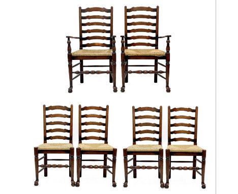 Six 20th century ash and oak ladder back chairs. With drop in rush seats and two carvers. (6)Stirdy, Some feline wear to two 
