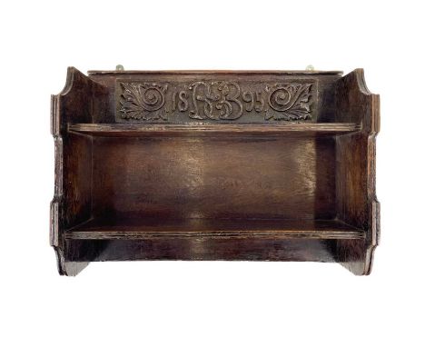 A Victorian oak carved shelf. Wall mounted shelf carved with date 1895 monogram cypher and foliate scrolls, height 48cm, widt