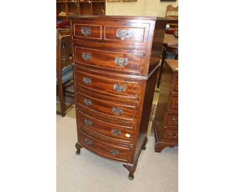 A modern mahogany finish bow-front narrow chest of six drawers on short cabriole legs, 50cm wide, 104cm high, a smaller mahog