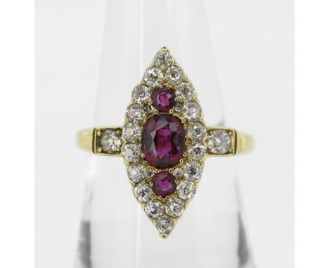 18CT YELLOW GOLD MARQUISE RUBY & DIAMOND CLUSTER RING, the central ruby (5.5 x 4.5mms) flanked by two smaller rubies, surroun