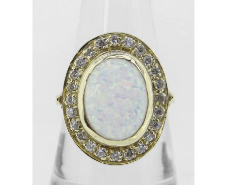 14K (585) YELLOW GOLD OVAL OPAL DRESS RING having border of twenty-four small diamonds, 6.8 grams. #Condition Report: Oval me