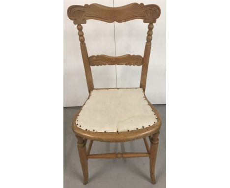 A vintage wooden bedroom chair with carved detail to back. Calico seat and turned stretcher and font legs. Approx 84cm high.