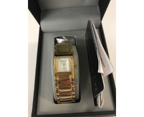 A boxed Diamond &amp; Co ladies  gold tone bracelet watch. Mother of pearl square face with hour and minutes hands. 8 diamond