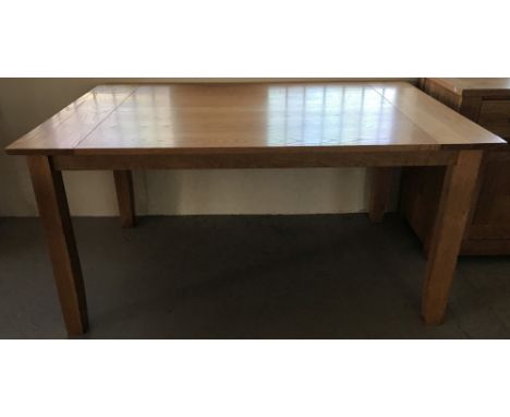 A light oak dining room table.  Approx. 150 x 90cm