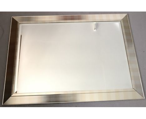 A modern rectangular mirror with subdued gold and silver striped frame.  Approx. 76 x 107cm (30 x 42 inches).