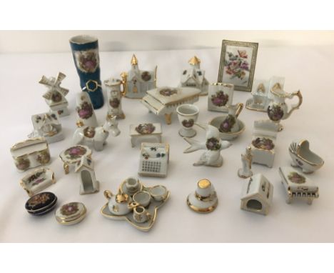 A collection of small Limoges ceramic ornaments. To include a dog in a kennel, miniature jug and bowl, miniature tea for two 