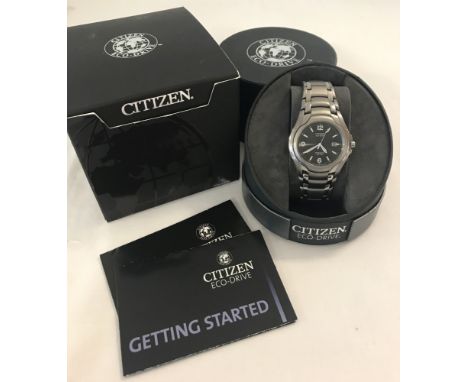 A men's boxed Citizen Eco-Drive titanium strap analogue wristwatch. Luminescent hours markers and hands. Seconds hand and dat
