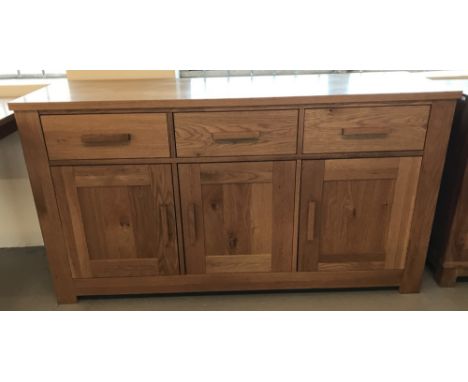 A light coloured sideboard with 3 horizontal drawers and 3 cupboards.  Approx. 150 x 48cm