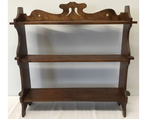 A small vintage dark wood shelf with decorative top plinth. Wall handing or free standing. Approx 60cm tall x 65 cm wide.