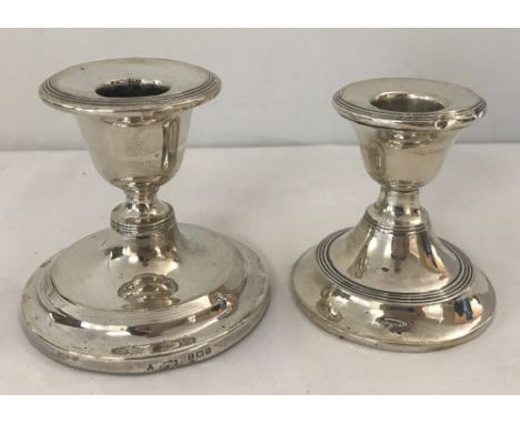 2 silver candlestick holders with filled bases. Hallmarked Birmingham 1907 and London 1920. 