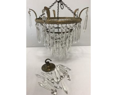 A small vintage decorative glass drop chandelier. 3 circular rows of drops with 4 single drops from top edge. 