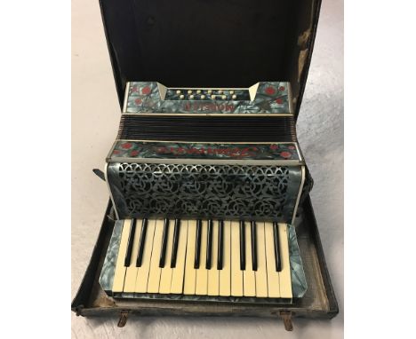 A vintage Francesco Modello accordion with blue marbled effect veneer and red flower inlay detail.&nbsp;Marked "Made in Saxon
