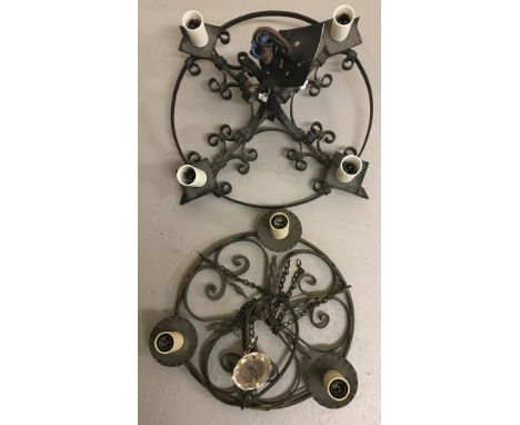 2 vintage wrought iron hanging candelabra. Both circular form with scroll pattern in centre. One with central hanging pole ap