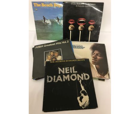 A collection of 13 vintage vinyl LP's to include The Beach Boys, Michael Jackson, Diana Ross &amp; Abba.  
