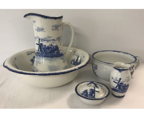 A blue and white Empire Ware 5 piece ceramic toilet set in "East Anglia" pattern. With Windmill and wherry boat design. Compr