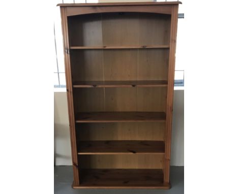 A honey coloured pine 4 shelf bookcase.  Approx. 147cm tall and 87cm wide.