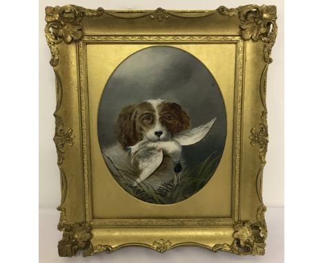 A gilt framed oil on board depicting a working dog with his find. With gold coloured oval shaped mount. Frame Size Approx. 43