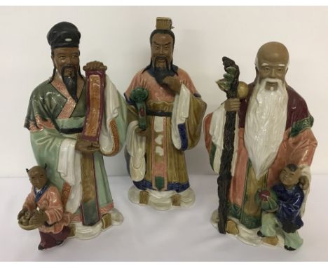 3 large  ceramic figures. In the shape of oriental robed gentlemen. 2 a/f.  Oriental stamp marks to inside of figures. Larges