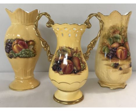 3 pieces of Aynsley "Orchard Gold" ceramics. Comprising: gilt handled Chantille mantel vase and 2 others. Tallest approx. 21c