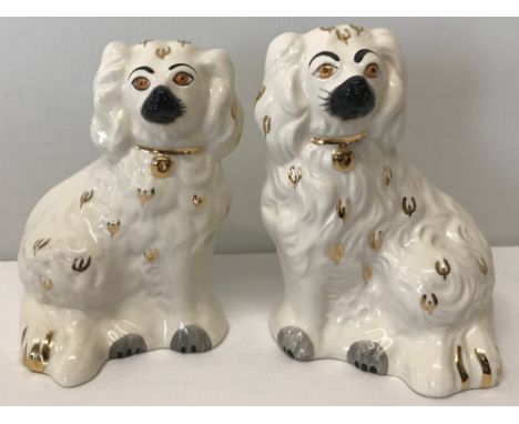 A pair of Beswick Staffordshire fireside dogs in white, black and gold colouration. Model #1878-6, complete with original gre